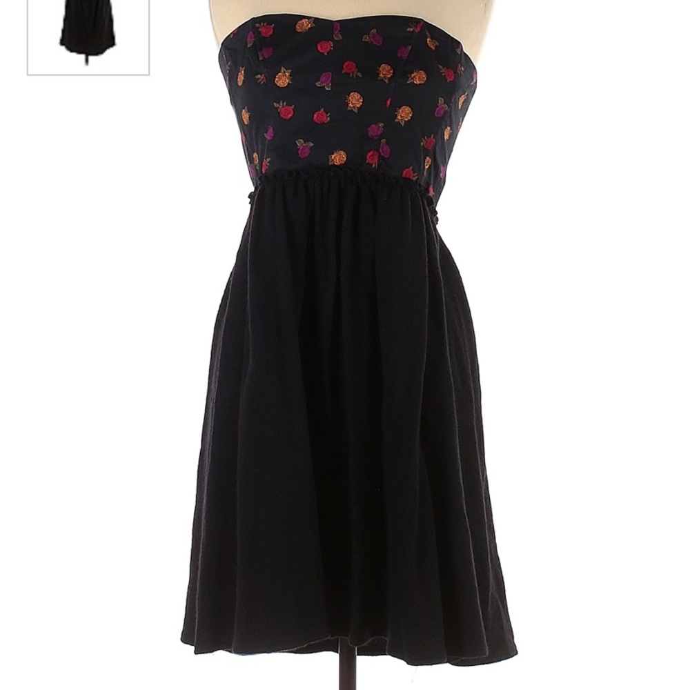 Black, sleeveless dress with rose pattern.
